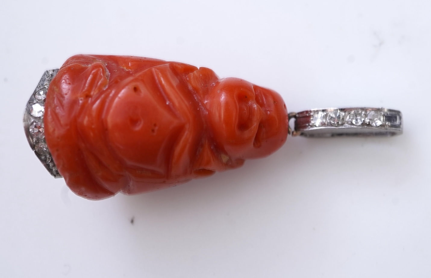 An Art Deco carved coral and diamond pendant, 1920s